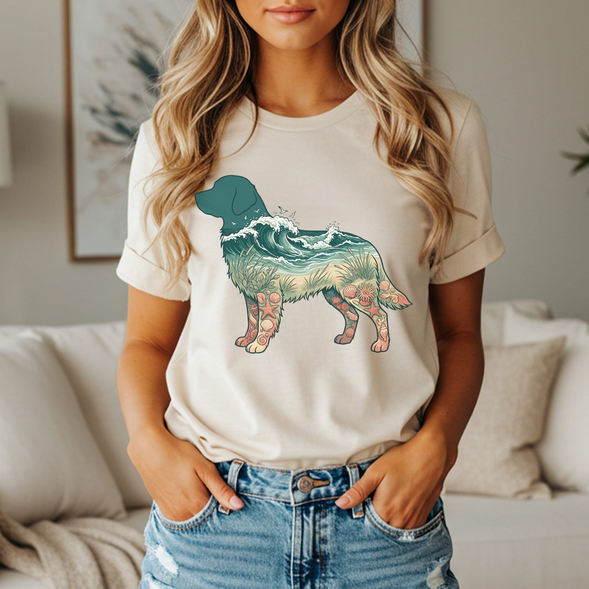 Cream t-shirt with a dog silhouette filled with ocean waves and seashells.