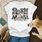 Four dogs wearing bandanas and sunglasses, printed on a white t-shirt.