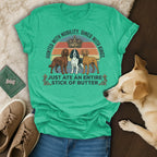 T-shirt with text "HUNTED WITH NOBILITY. DINED WITH KINGS. JUST ATE AN ENTIRE STICK OF BUTTER." featuring three dogs.