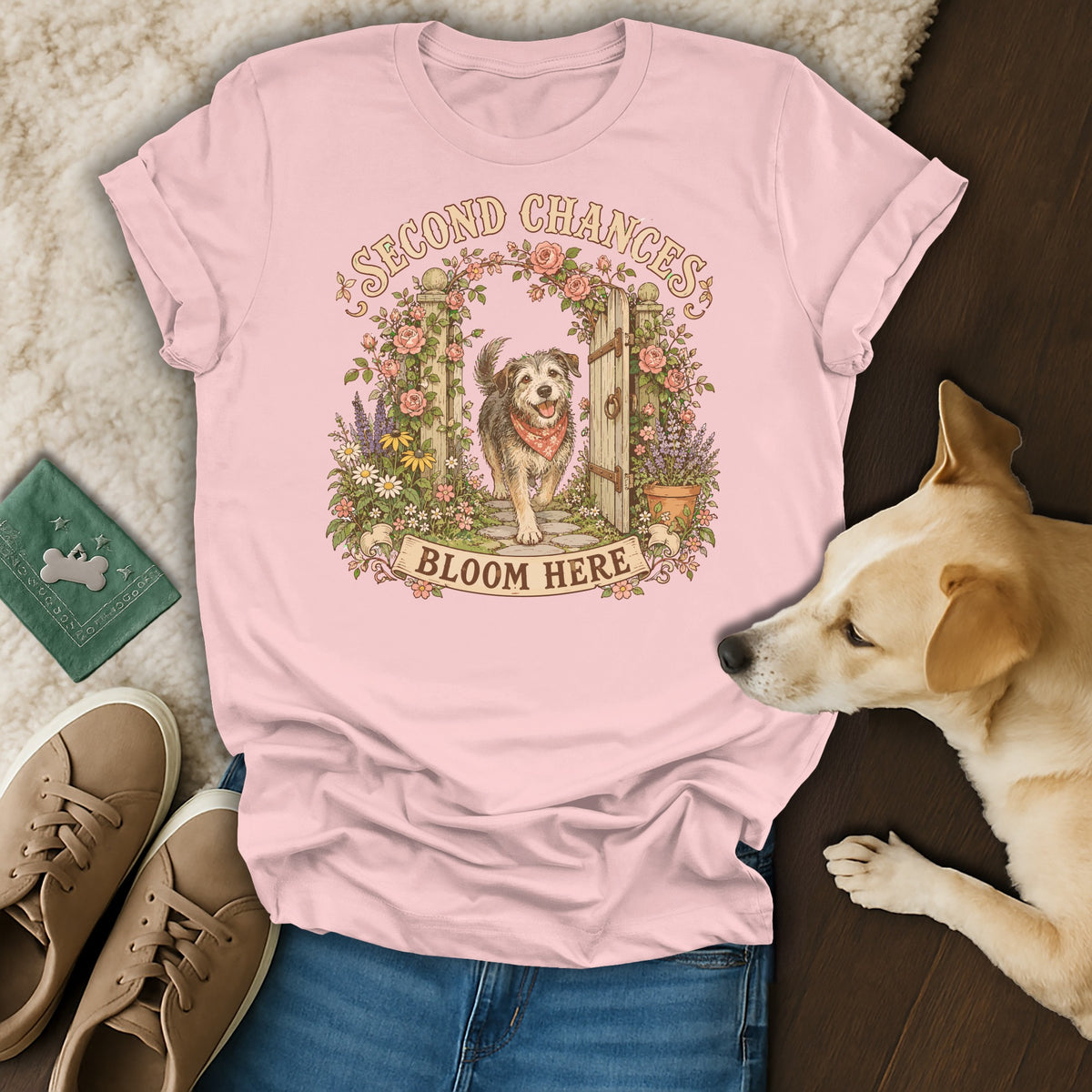 Pink t-shirt with a vintage illustration of a dog, flowers, and the text Second Chances Bloom Here.