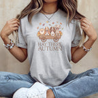T-shirt graphic with four dogs in a wagon, text "HAY THERE AUTUMN" and autumn leaves.