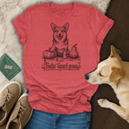 Red t-shirt with a drawing of a corgi sitting with pumpkins and the text "Feelin' Gourd-geous".