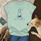 Light green t-shirt with blue graphic of a dog wearing a party hat and holding a balloon, text reads "PITTY PARTY."