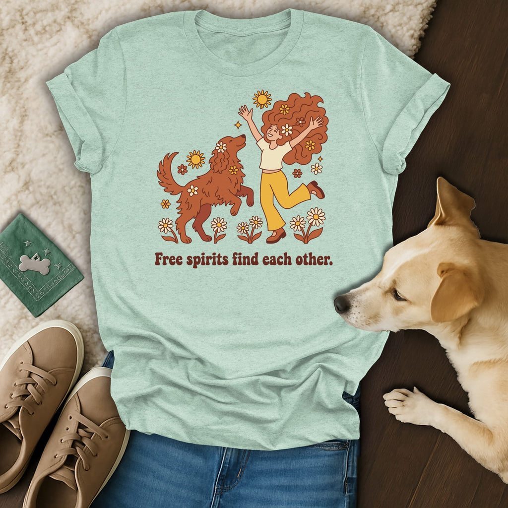 T-shirt with graphic of two people with flowers and a dog, text "Free spirits find each other."