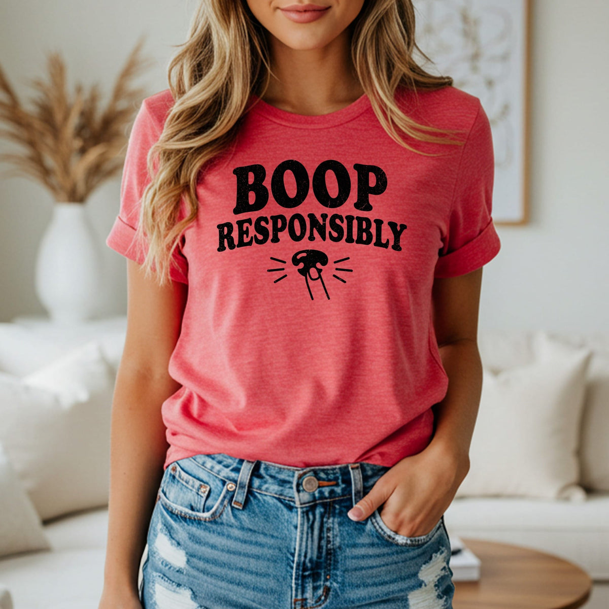 Pink t-shirt with black text "BOOP RESPONSIBLY" and a cat nose graphic.