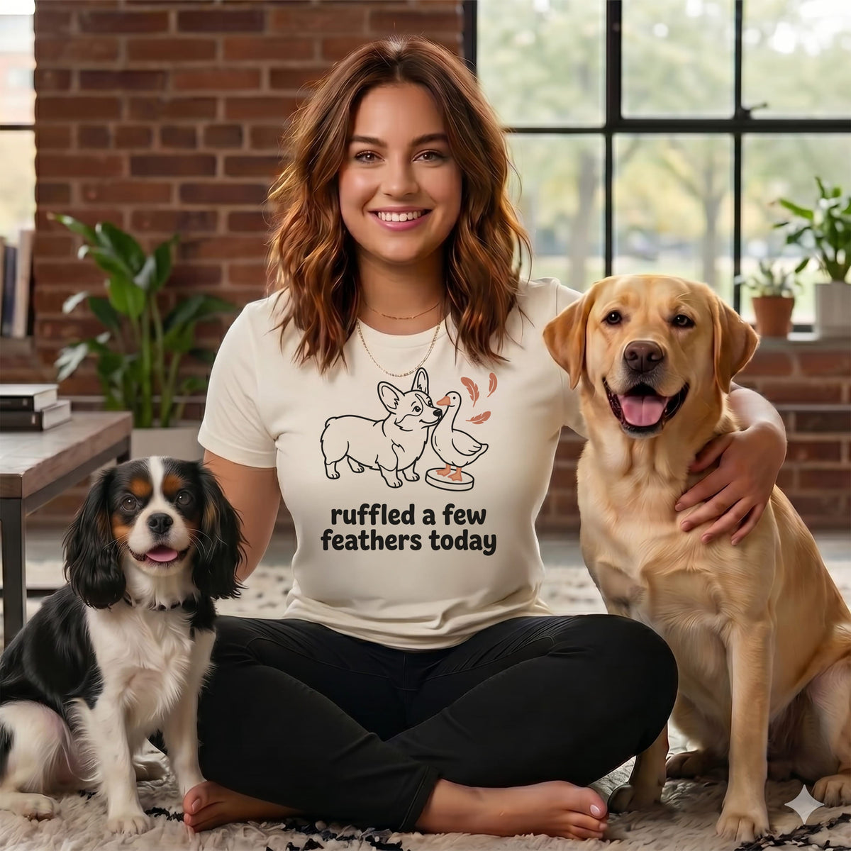 Woman in t-shirt with corgi and duck graphic and text "ruffled a few feathers today" with two dogs.