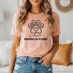 Peach t-shirt with "Pawprints on My Heart" and paw print graphic.