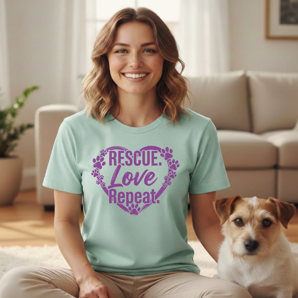 Light teal t-shirt with purple paw print heart graphic saying "RESCUE Love Repeat".