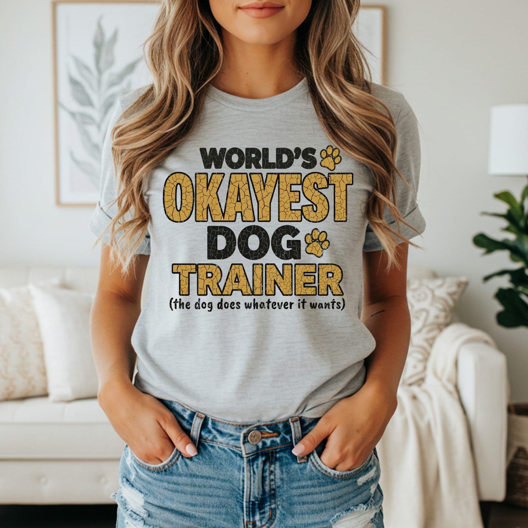 Grey t-shirt with "World's Okayest Dog Trainer" text.