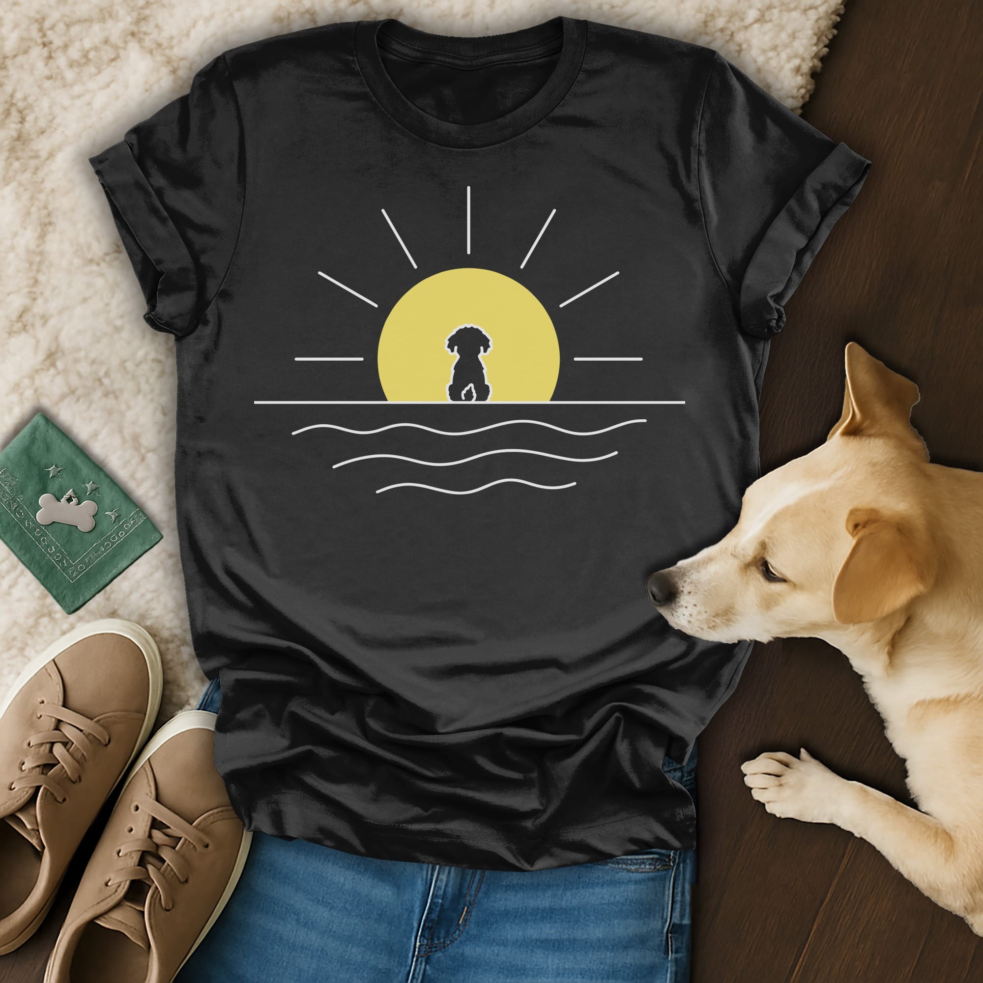 Black t-shirt with a yellow sun and dog silhouette over a water line.