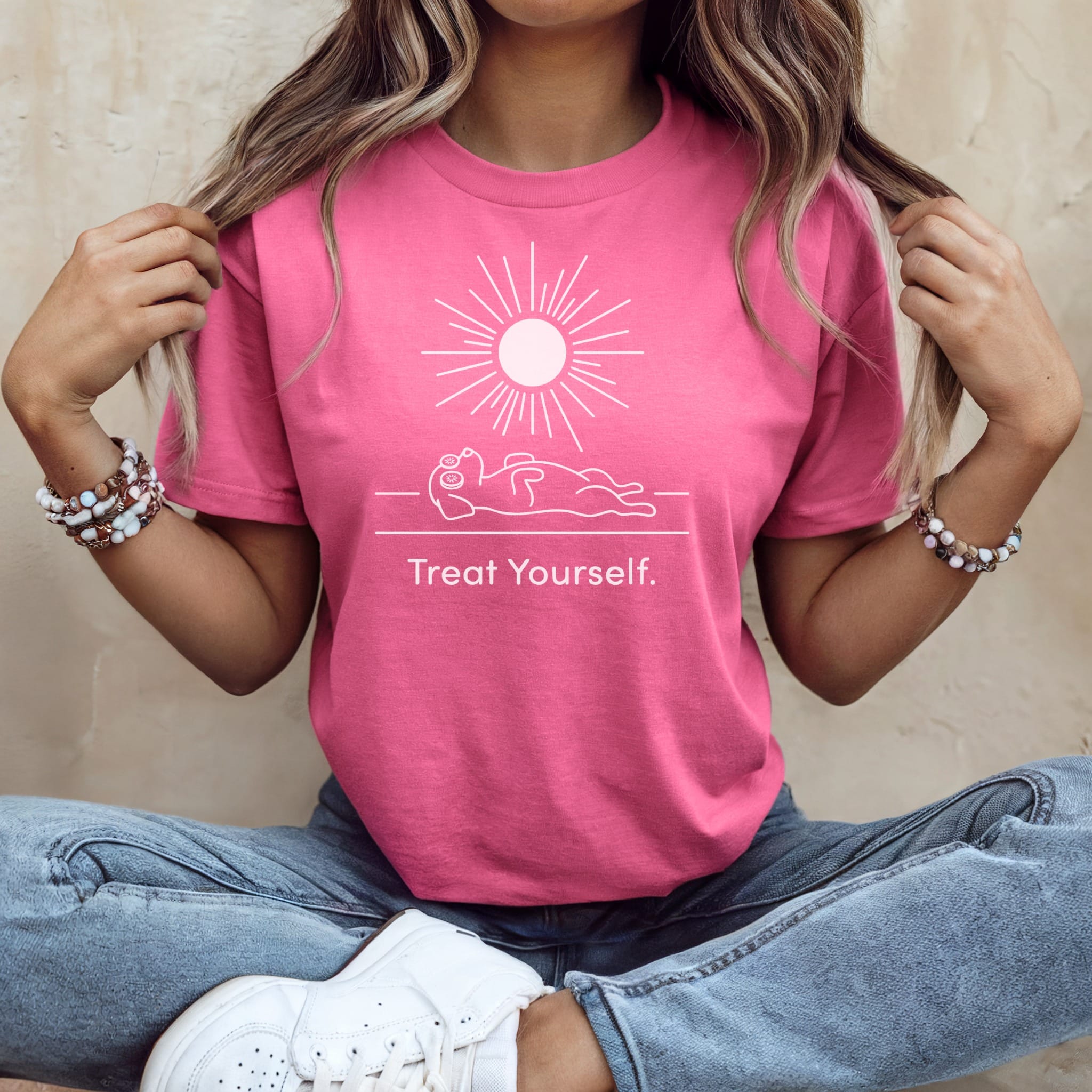 Pink t-shirt with sun graphic and "Treat Yourself." text.