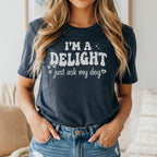 Dark blue t-shirt with "I'm a delight just ask my dog" text and paw prints.