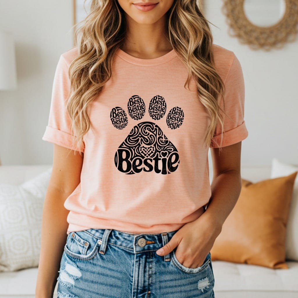 Peach t-shirt with "Bestie" text design inside a paw print.