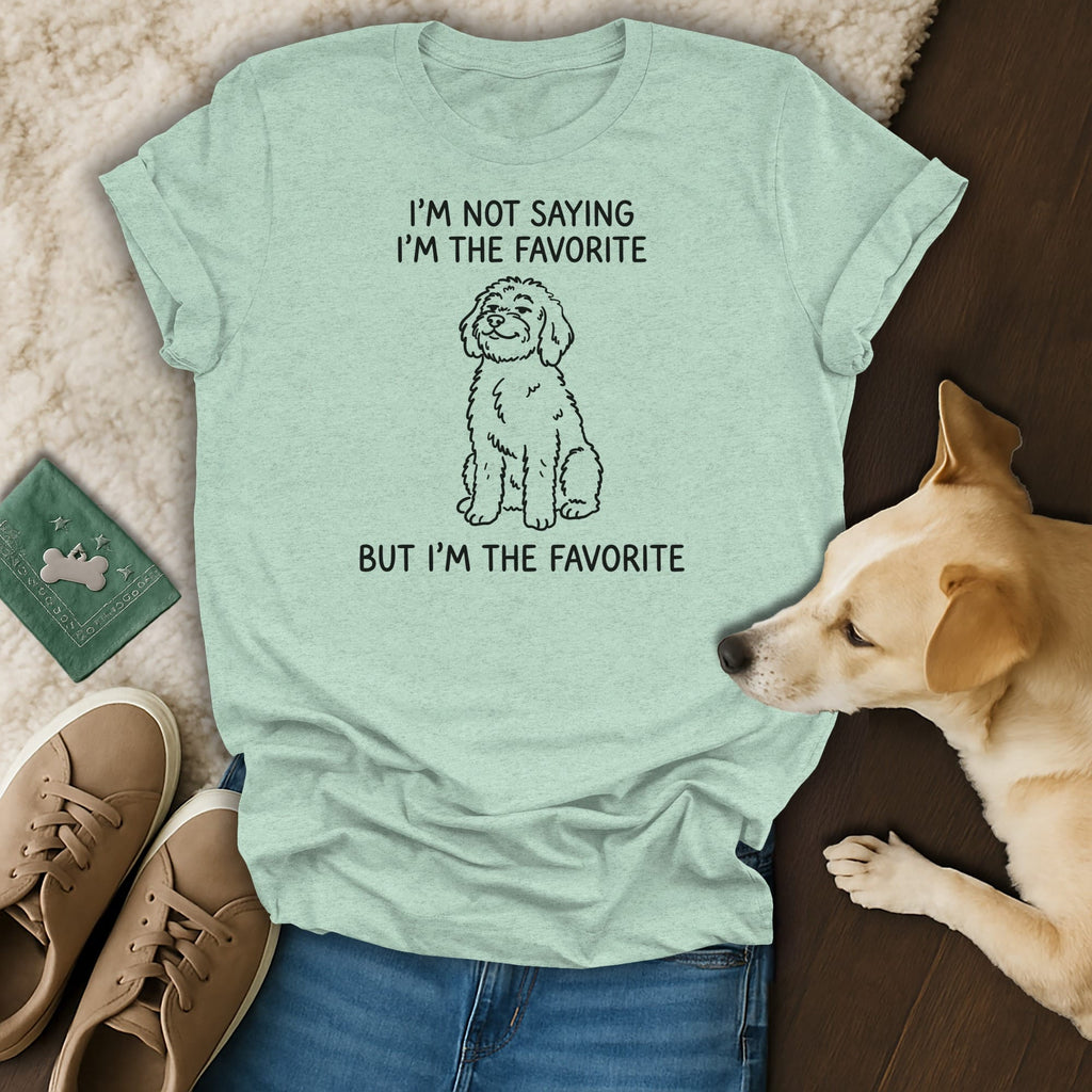 Light green t-shirt with black text "I'm not saying I'm the favorite but I'm the favorite" and dog graphic.