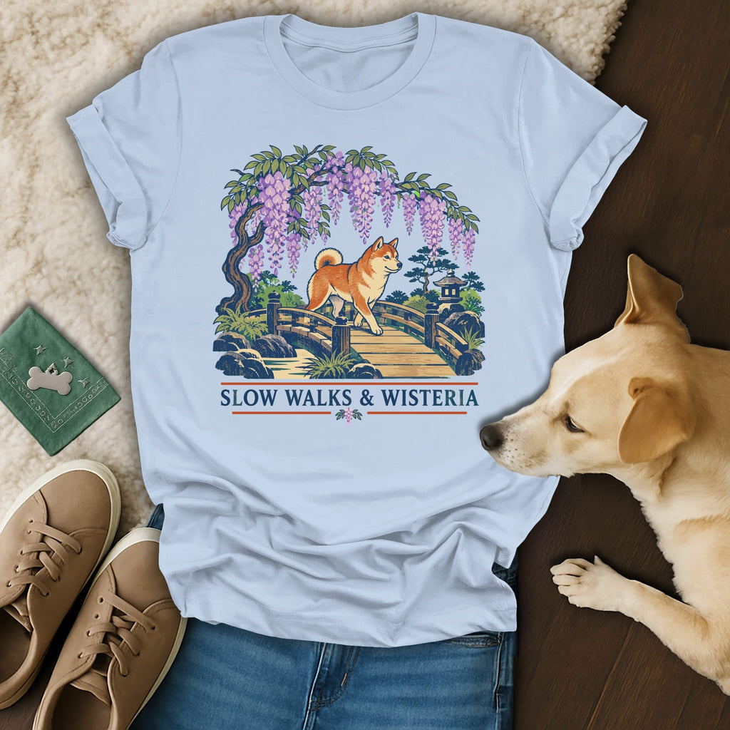 Light blue t-shirt featuring a Shiba Inu on a bridge beneath wisteria, with "SLOW WALKS & WISTERIA" text.