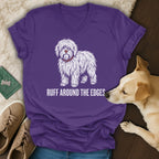Purple v-neck t-shirt with white distressed dog graphic and text "RUFF AROUND THE EDGES."