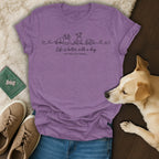 Purple t-shirt with line drawings of dogs and text "Life is better with a dog OR TWO, OR THREE..."
