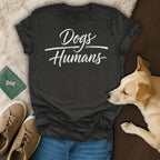 Dark gray t-shirt with "Dogs Humans" in white cursive text.