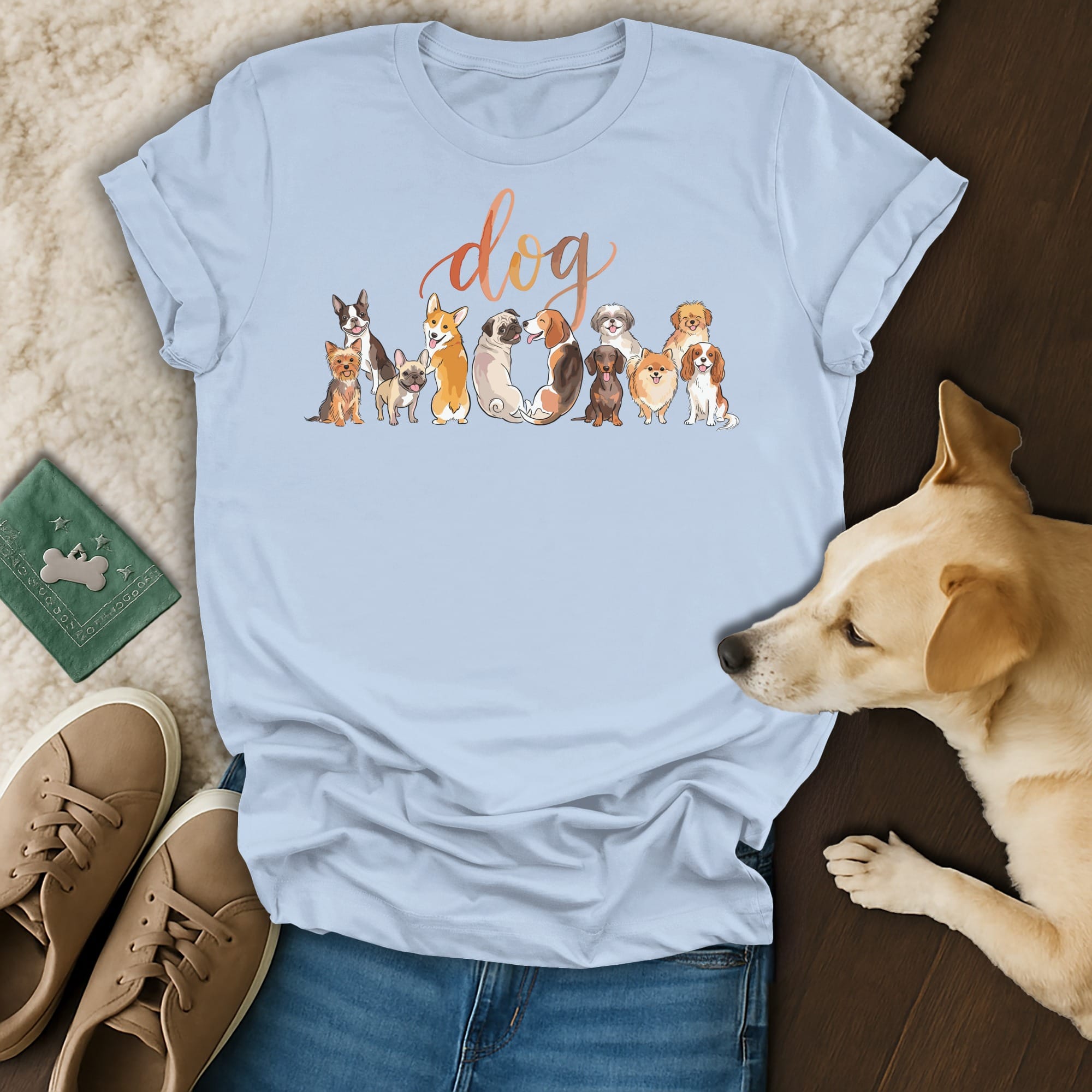 Light blue t-shirt with "dog" in script and a line of cartoon dogs on the chest.