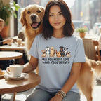 Woman with dogs on t-shirt with text "ALL YOU NEED IS LOVE AND A DOG'OR FIVE".