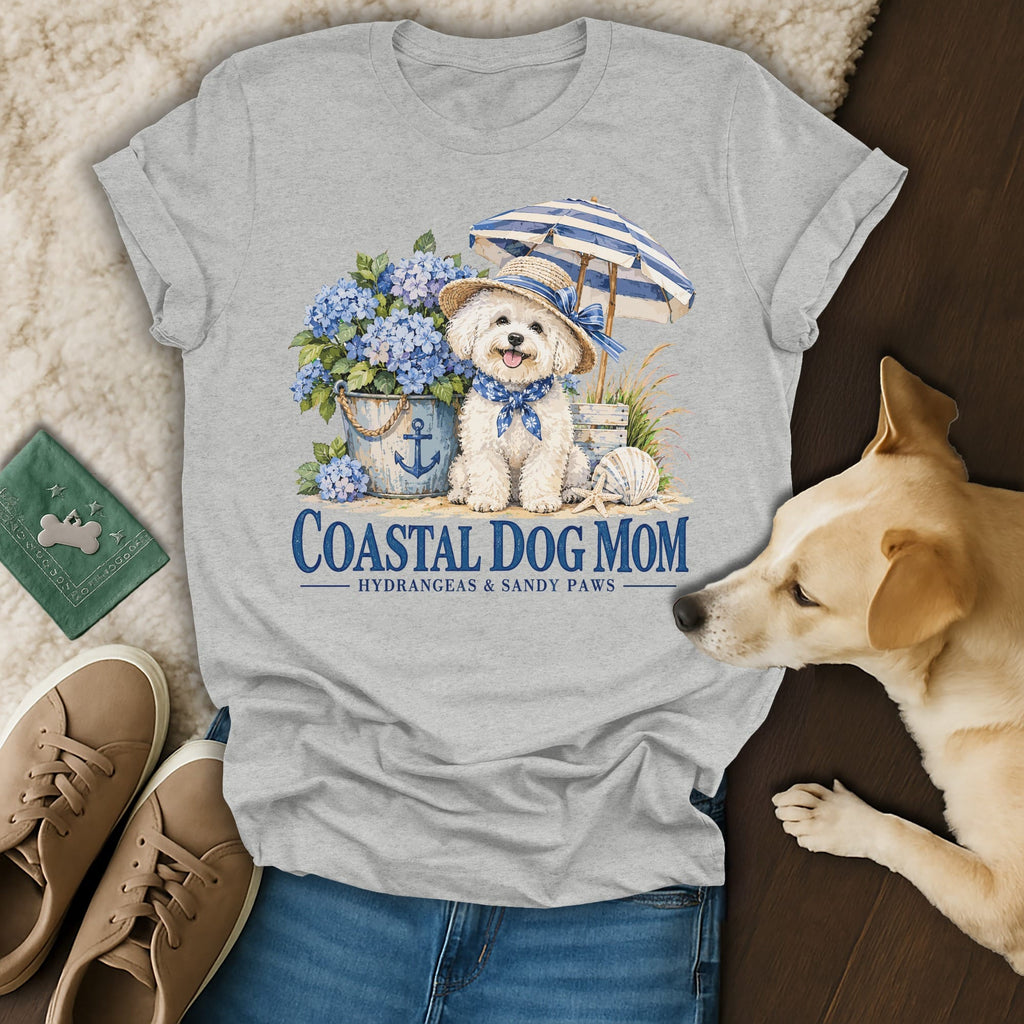 Heather gray t-shirt featuring a graphic of a dog, beach umbrella, and hydrangeas, with Coastal Dog Mom text.