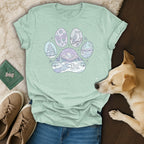 Light blue t-shirt with winter-themed paw print graphic and dog.