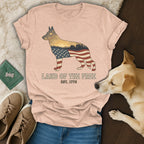 Dog silhouette filled with American flag pattern and scenic landscape.