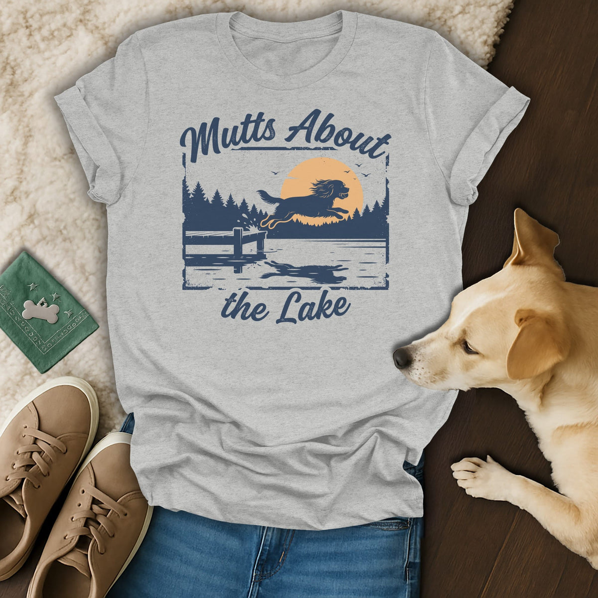 Grey t-shirt with graphic of dog jumping into a lake, text "Mutts About the Lake".