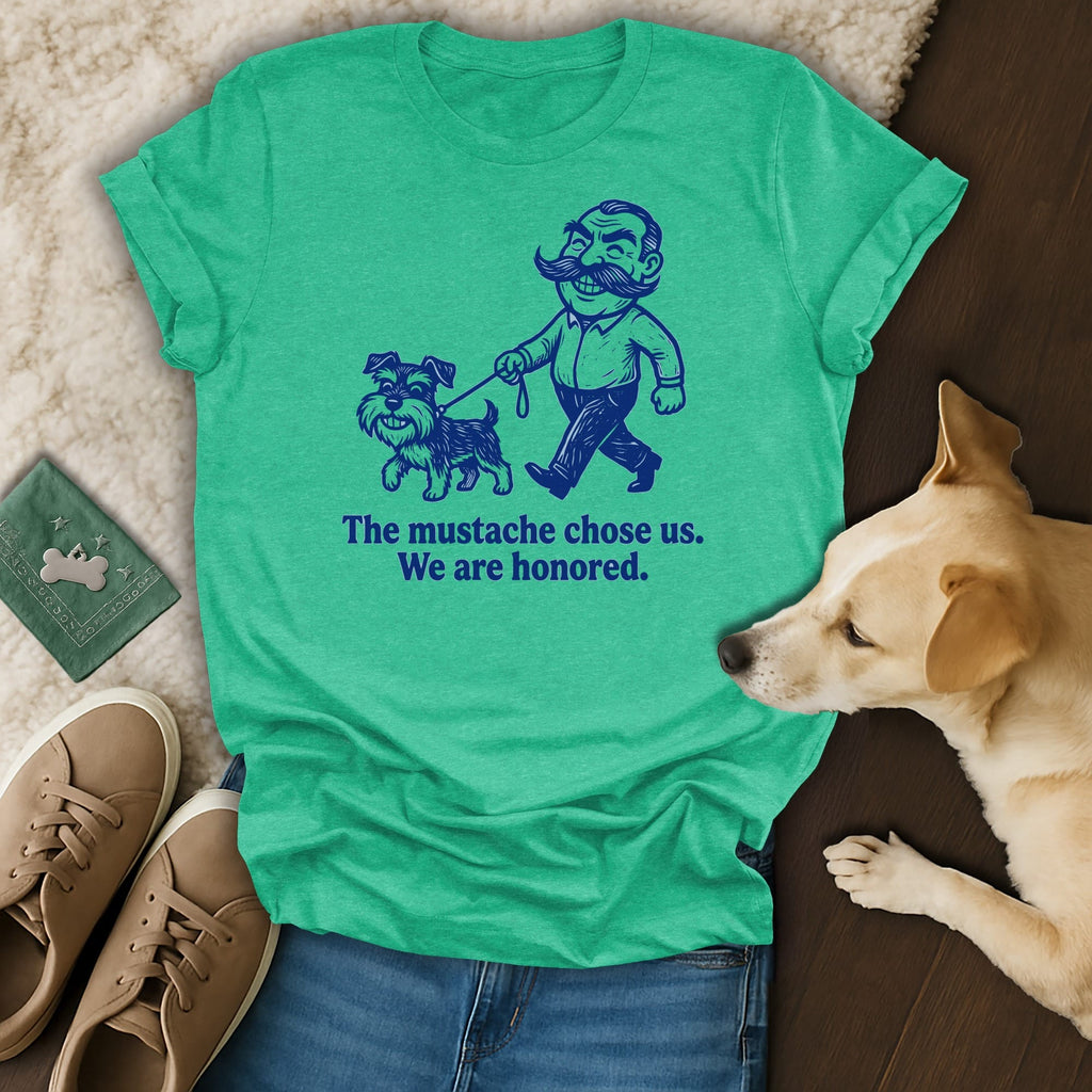 Green t-shirt with a cartoon man and dog, reads "The mustache chose us. We are honored."
