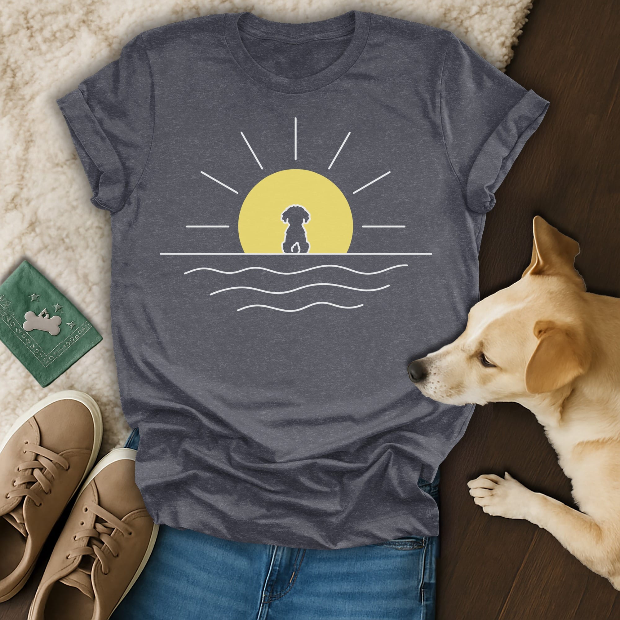 T-shirt with a dog silhouette against a setting sun over water.