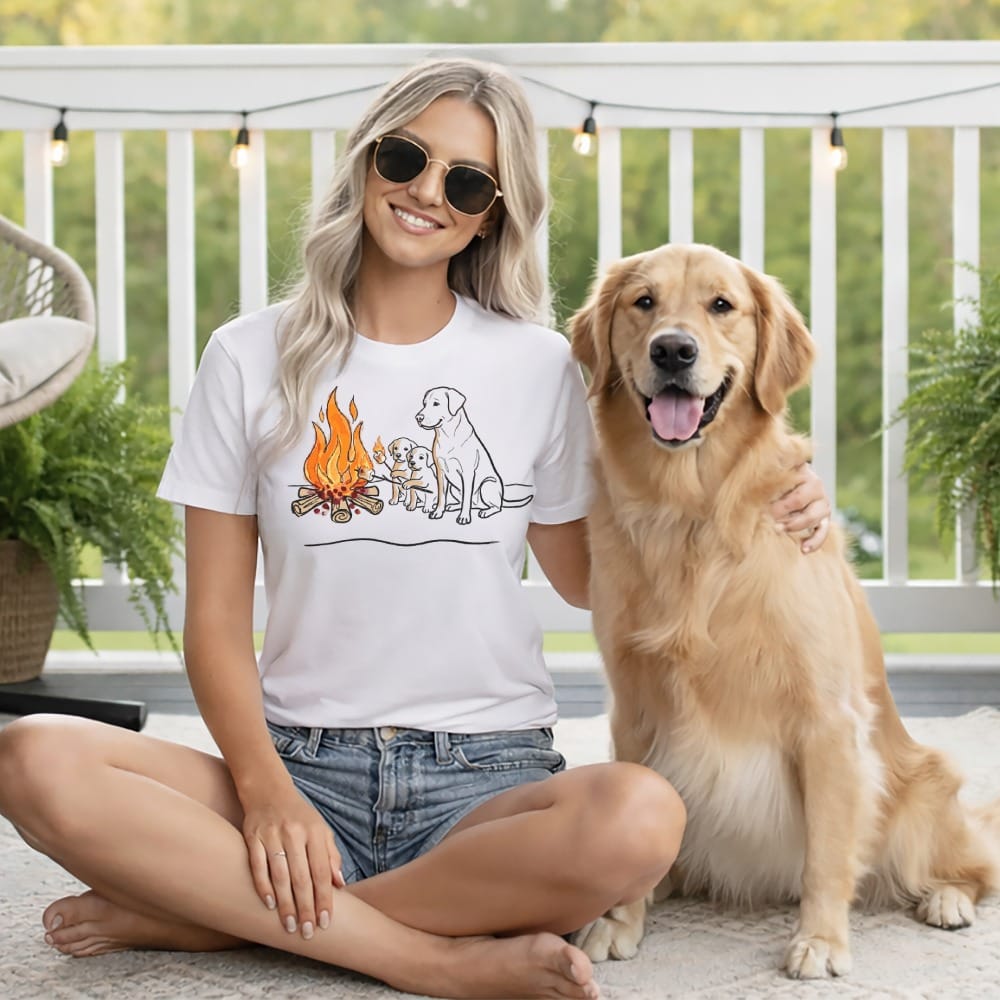 Woman and golden retriever wearing t-shirt with campfire and dog cartoon.