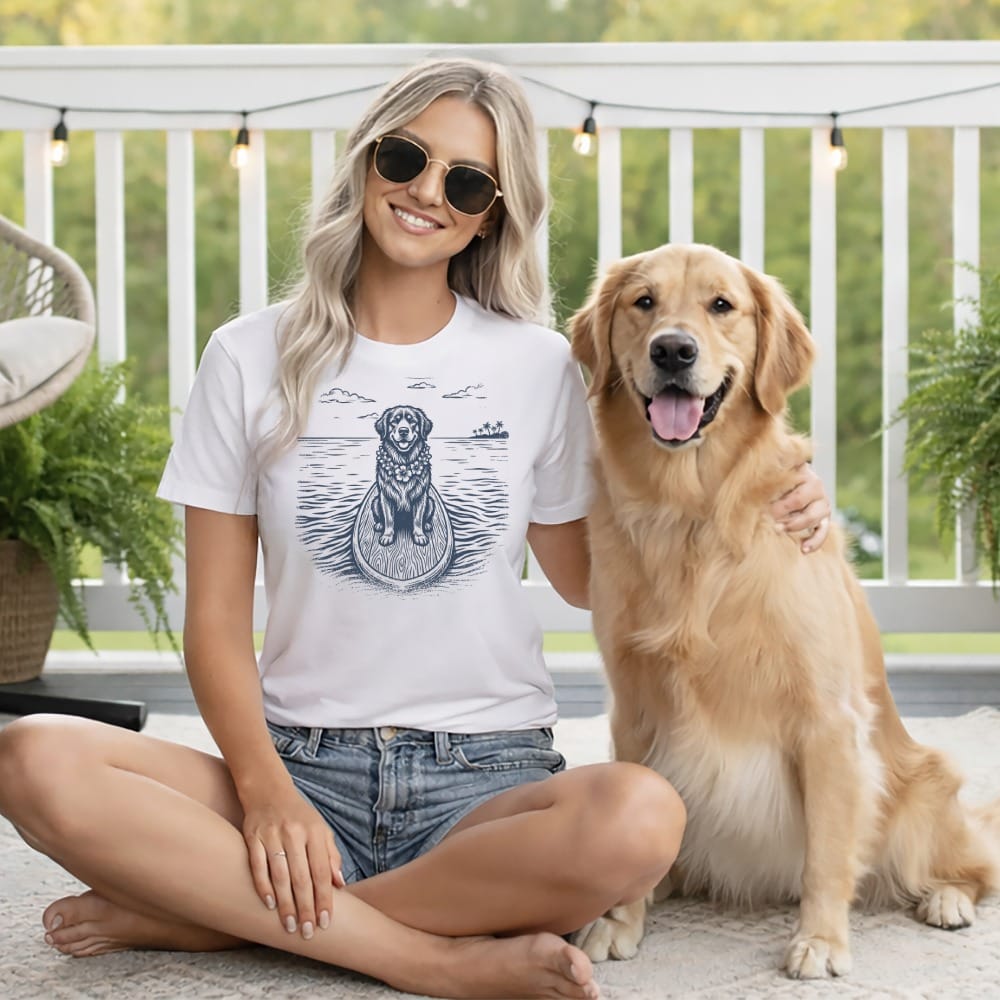 Woman and golden retriever on a surfboard graphic on t-shirt.
