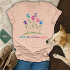 Peach t-shirt with colorful paw prints, flowers, and butterfly, "Where the wild paws grow".