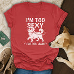 Red t-shirt with white text and dog graphic reading "I'M TOO SEXY FOR THIS LEASH".