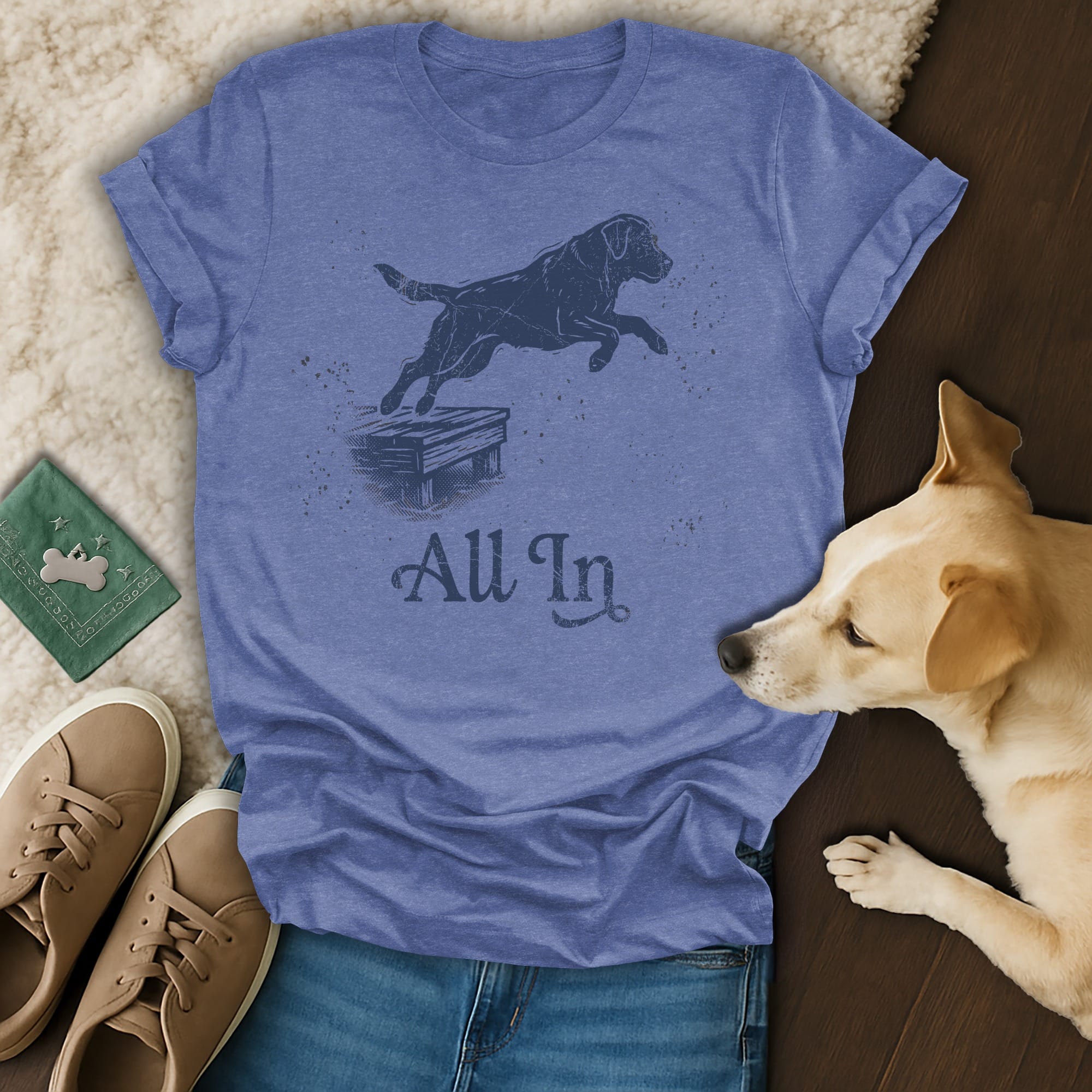 Blue t-shirt with a dog jumping over a wooden obstacle, text "All In".