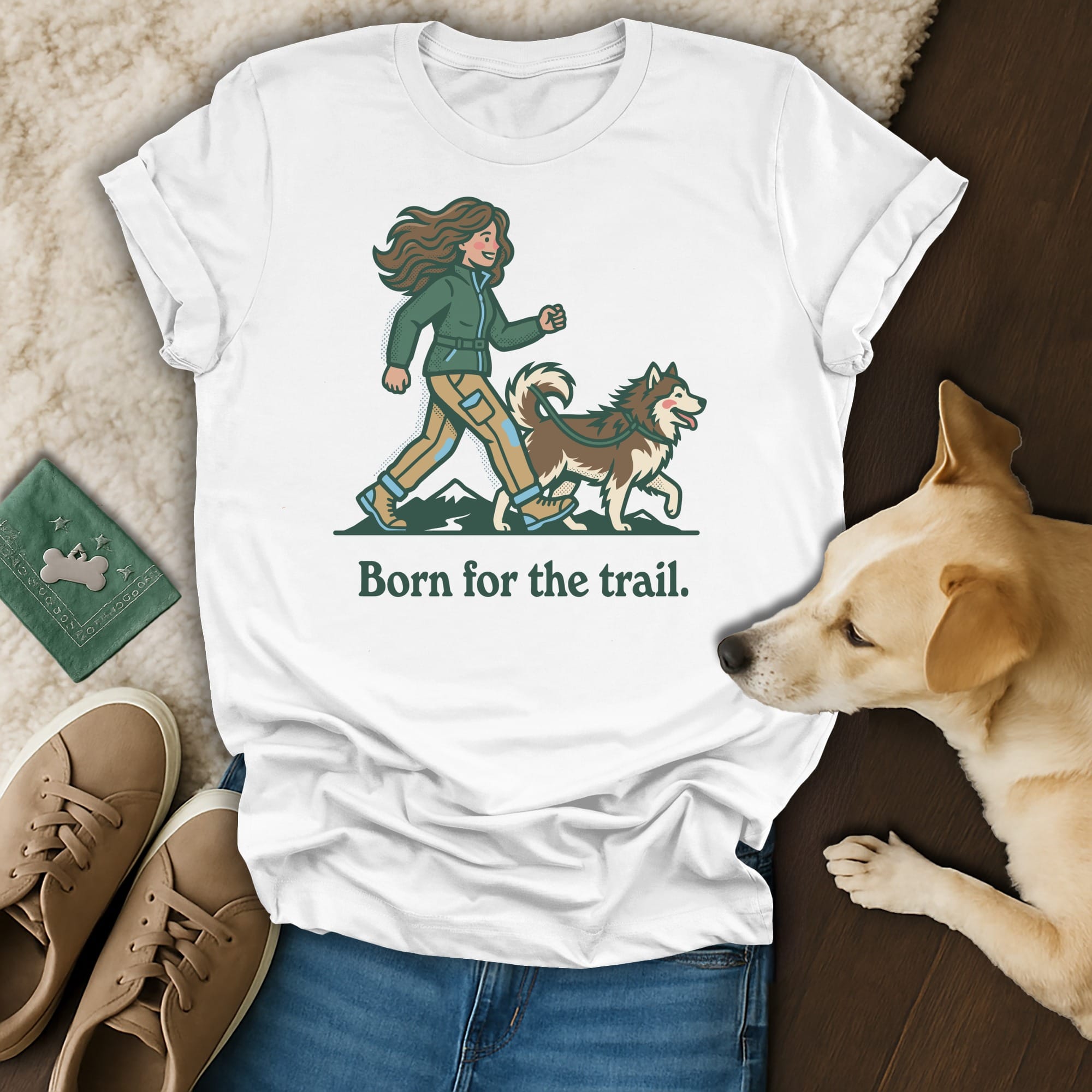 White t-shirt with illustration of woman and dog, "Born for the trail." text.