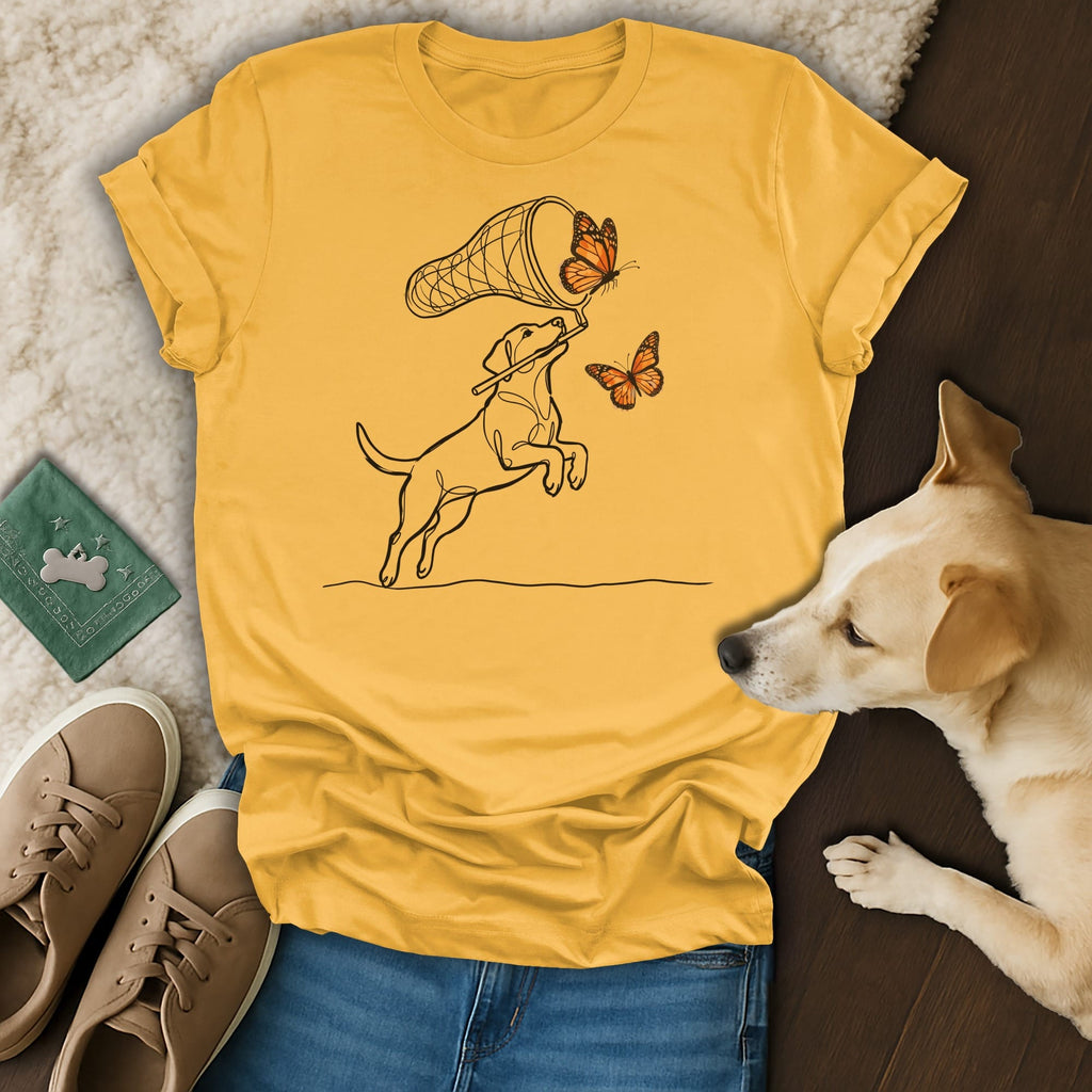 Yellow t-shirt with black line drawing of a dog catching butterflies.