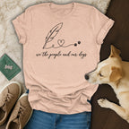Peach t-shirt with "we the people and our dogs" and feather/paw print design.