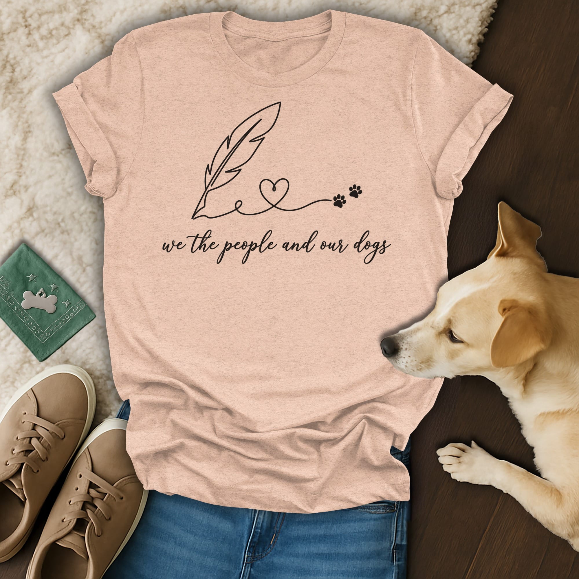 Peach t-shirt with "we the people and our dogs" and feather/paw print design.