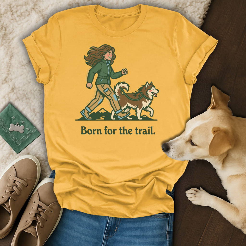 Yellow t-shirt with "Born for the trail." slogan and illustration of person walking dog.