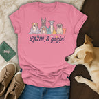 Pink t-shirt with cartoon dogs and the text "LAZIN' & gazin'".