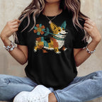 Black t-shirt with a cartoon corgi holding a flower, wearing a colorful bandana.