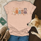 T-shirt with a cartoon illustration of five dogs in sweaters, pumpkins, acorns, and autumn leaves.