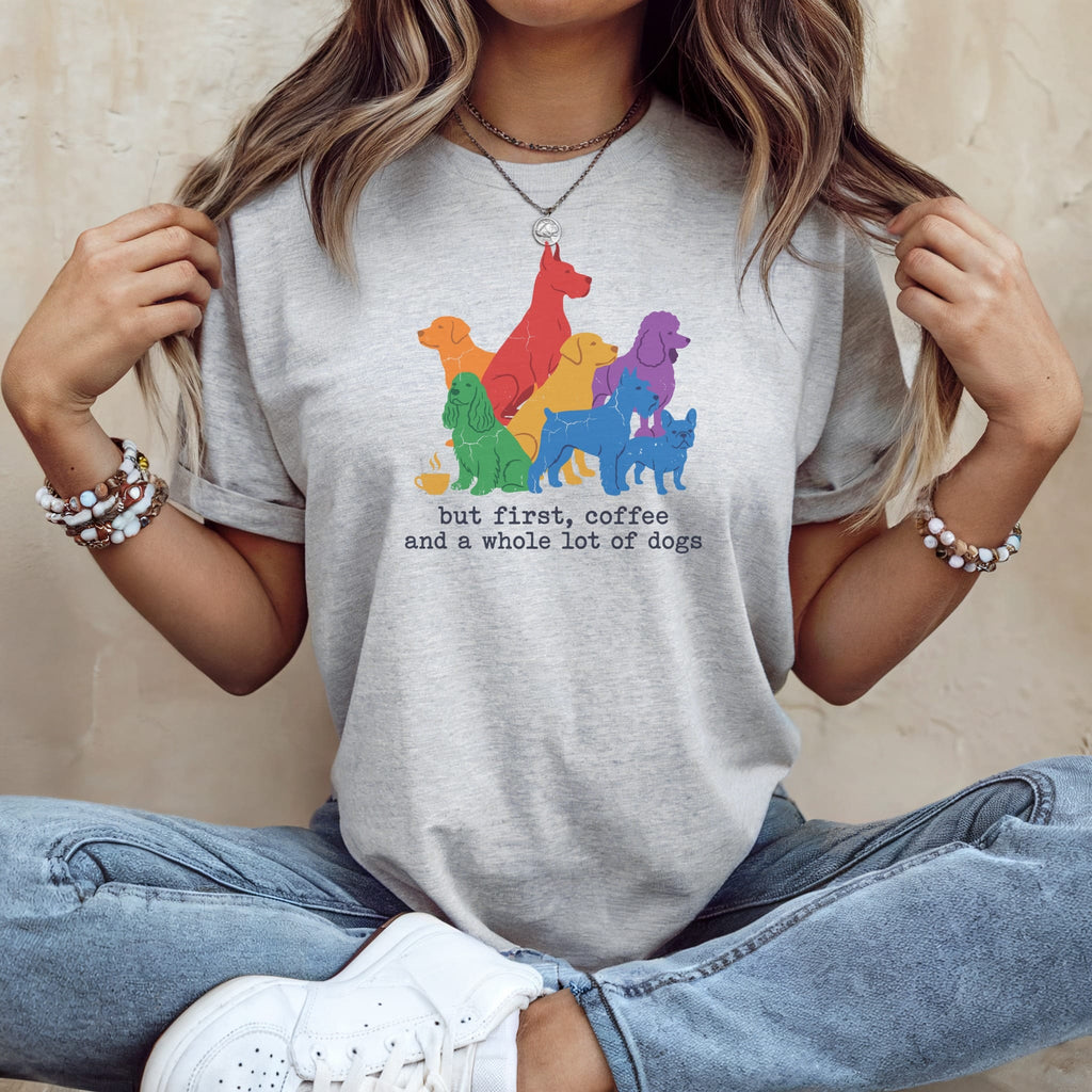 Grey t-shirt with colorful dogs and text "but first, coffee and a whole lot of dogs."