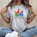 Grey t-shirt with colorful dogs and text "but first, coffee and a whole lot of dogs."