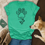 Green t-shirt with a black line art design of a paw print, rose, and hearts.