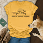 Yellow t-shirt with a black line drawing of a running dog and text "Runnin' on Treats and Adrenaline".