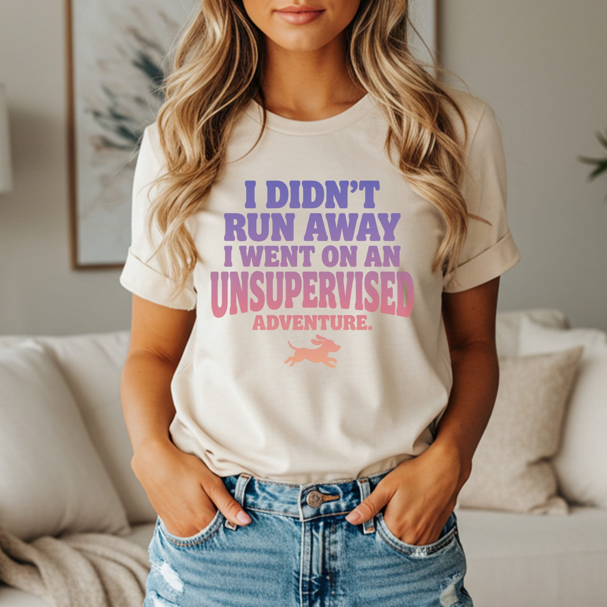 Cream t-shirt with purple and pink text: "I didn't run away, I went on an unsupervised adventure."