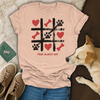 Peach t-shirt with tic-tac-toe design featuring paw prints, bones, hearts, and text.