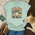 T-shirt with "Rescue Squad" text and three cartoon dogs, featuring a beige dog in the foreground.